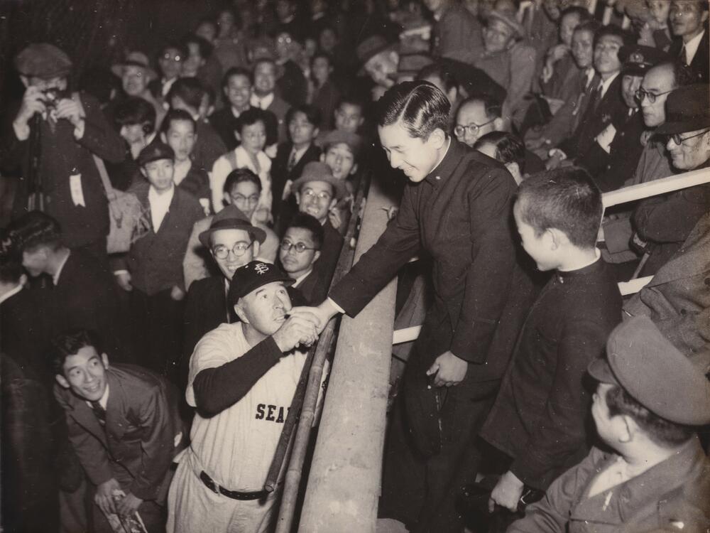 Lefty O'Doul shakes hands with Crown Prince Akihito (at that time future emperor, now abdicated emperor) during the 1949 SF Seals Goodwill Tour to Japan during the Allied occupation.