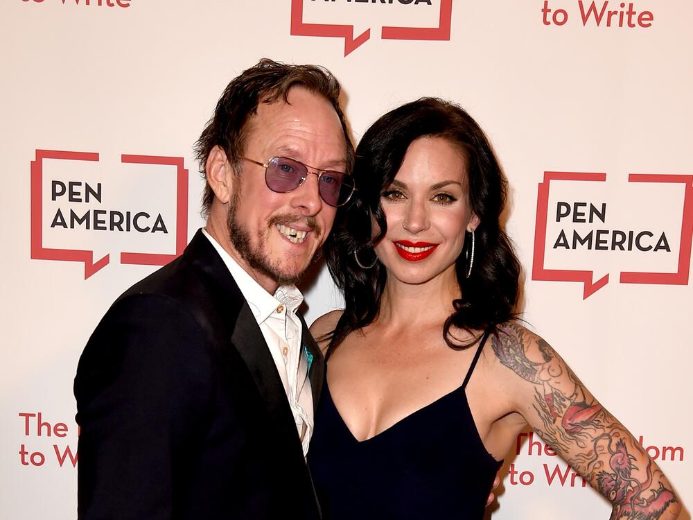 When police came to the cul de sac road in Los Angeles where Jillian Lauren lives with her husband, Weezer bassist Scott Shriner, they were pursuing a suspect in a hit-and-run. But Lauren was shot after police say she pointed a gun at them. The couple are seen here in 2018.
