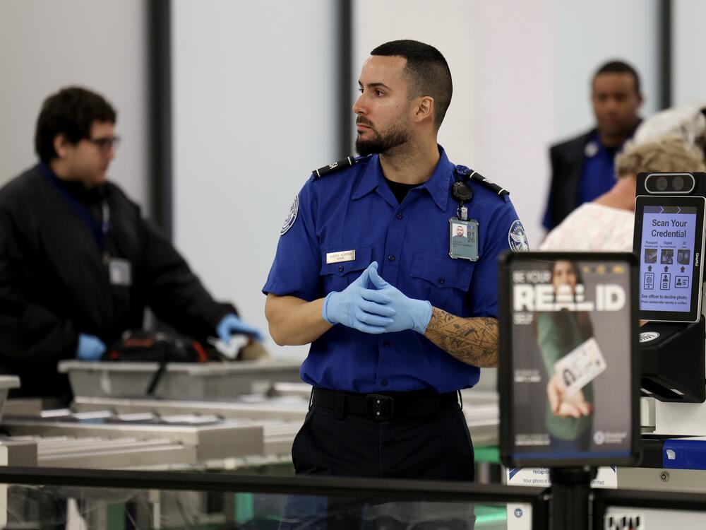 A Transportation Security Administration agent stands at a security checkpoint at Miami International Airport on Dec. 20, 2024. The federal government is preparing to begin implementing Real ID rules in May.
