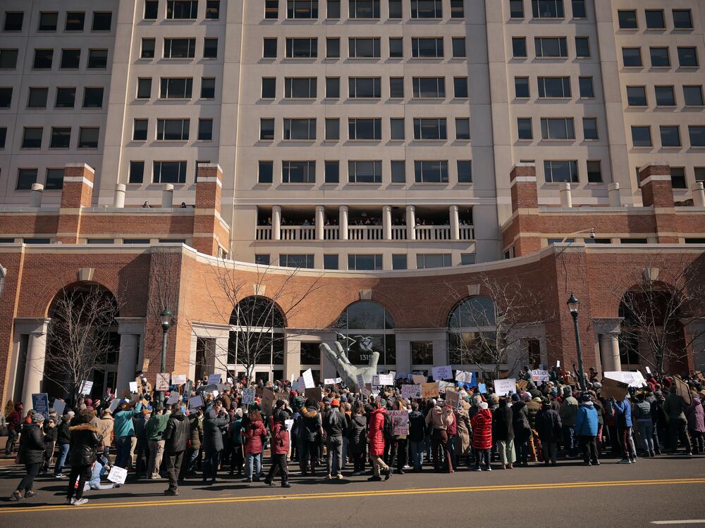 Hundreds of demonstrators gathered outside the headquarters of the National Oceanic and Atmospheric Administration in March to protest Department of Government Efficiency (DOGE) cuts to the agency. The Trump administration continues to make major staffing and programming changes at the agency.
