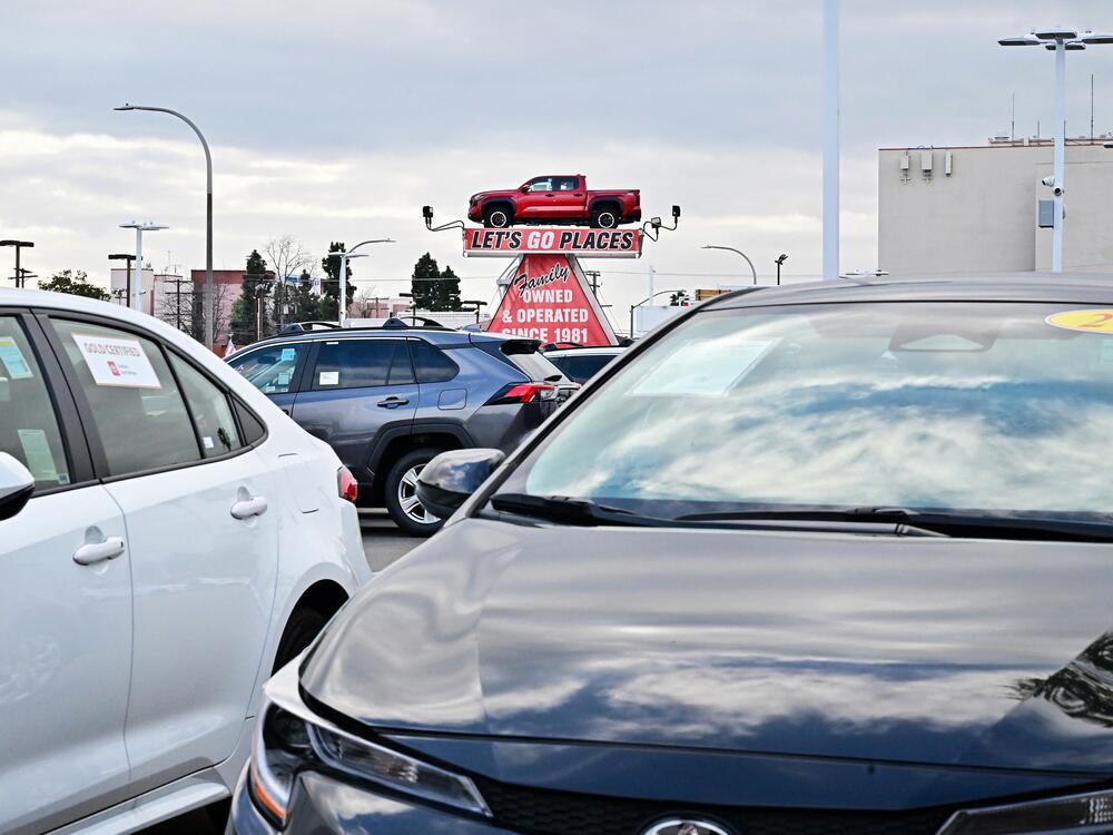 A pickup truck is raised for display at a car dealership in Alhambra, California, on March 27, 2025. After President Trump announced significant tariffs on imported vehicles and parts, automaker stocks fell sharply. But sales at dealerships rose, at least in the short-term, as buyers try to get ahead of the anticipated price spikes in the coming months.