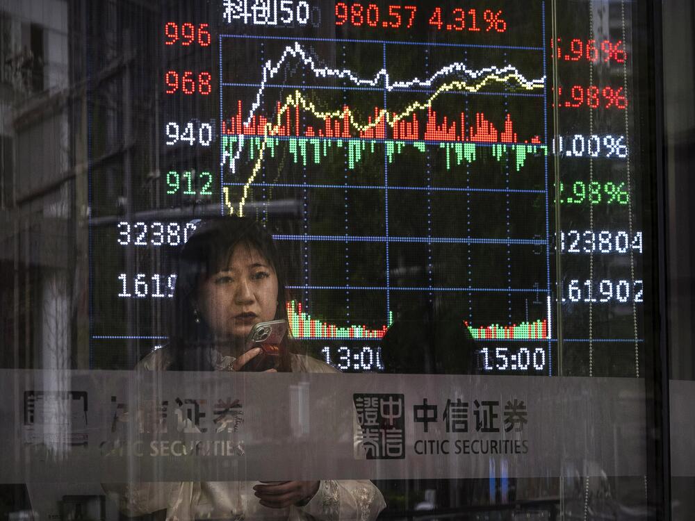 A stock ticker shows trading at a securities firm in Beijing April 9.