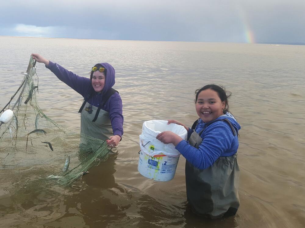 Alannah Hurley and her daughter Dellana Mann fish for smelt, a seasonal fish eaten, shared and bartered by Alaska Native people.