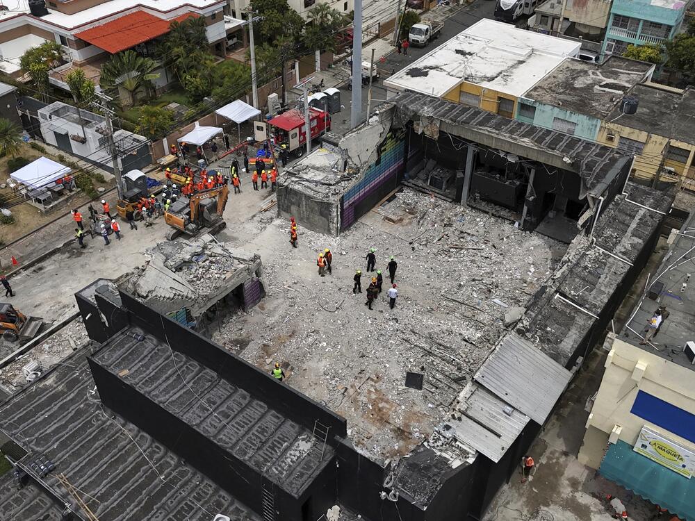 Rescue workers stand at the Jet Set nightclub days after its roof collapsed, killing more than 200 people in Santo Domingo, Dominican Republic on Thursday.