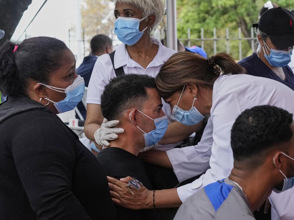 A person is comforted before identifying the body of a family member who died at the Jet Set nightclub, days after its roof collapsed during a concert and killed more than 200 people, outside the National Institute of Forensic Pathology in Santo Domingo, Dominican Republic on Thursday.