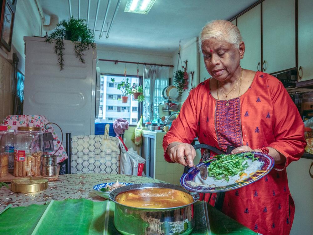 The photographer's mother, Puvaneswari Kannusamy, makes her version of tomato <em>rasam</em>, also known in Tamil as <em>thakkali rasam</em>, in her kitchen in the family's four-room public housing unit in Farrer Park, Singapore.