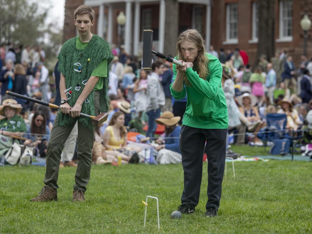 St. John's Caden Marshall swings the mallet as teammate Leo Schumwinger looks on.
