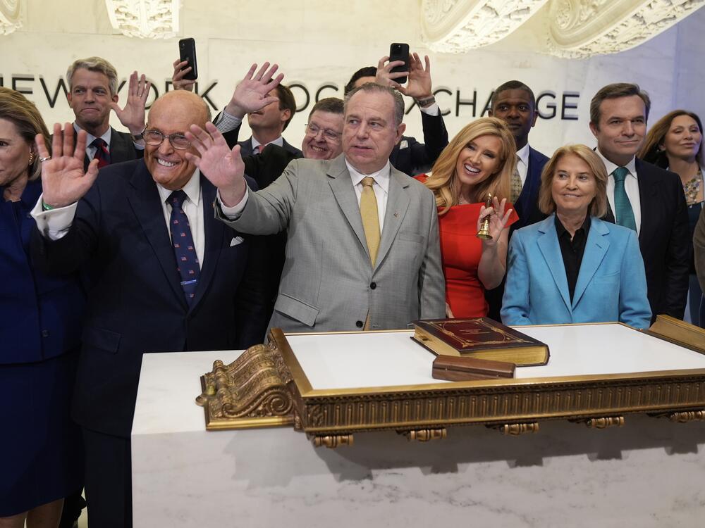 Newsmax CEO Christopher Ruddy, center, and former New York Mayor Rudy Giuliani, center left, celebrate the conservative network's initial public offering on the floor of the New York Stock Exchange on April 3.