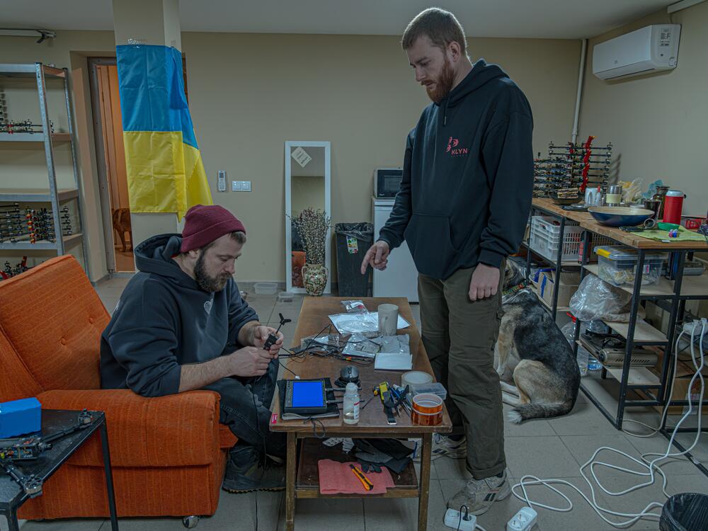 Drone makers Oleksandr Ptashnyk (left) and Andrii Yukhno in their workshop. Ptashnyk, a dancer, says he's making drones to help Ukraine end this war on the best terms it can.