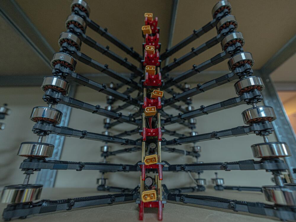 A stack of carbon fiber drone frames ready to be loaded up with engines, cameras and transmitters.