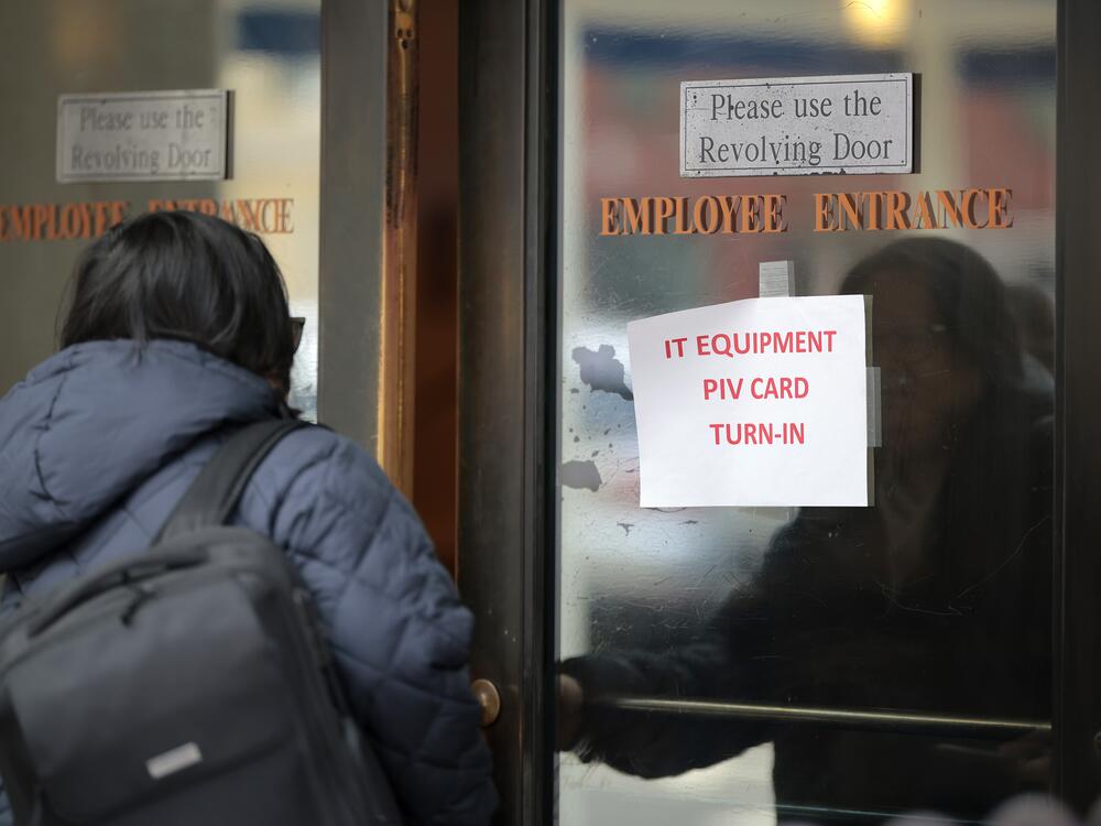 A person walks into the Department of Veterans Affairs' headquarters a block from the White House on March 6. President Trump and Elon Musk's DOGE effort targets about 80,000 jobs to be cut from the VA.