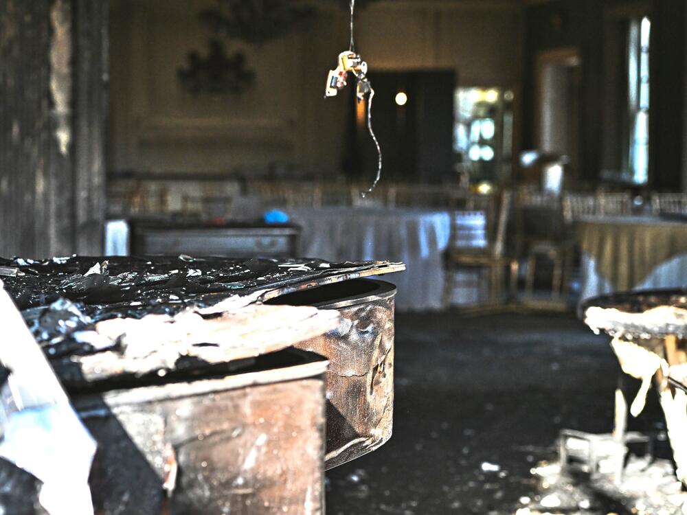 A charred piano, left, is visible inside the Pennsylvania governor's official residence after a man was arrested in the alleged arson that forced Gov. Shapiro, his family and guests to flee in the middle of the night on the Jewish holiday of Passover on Sunday.