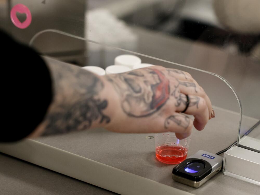 A woman reached for a dose of methadone at the Behavioral Health Network opioid treatment clinic.