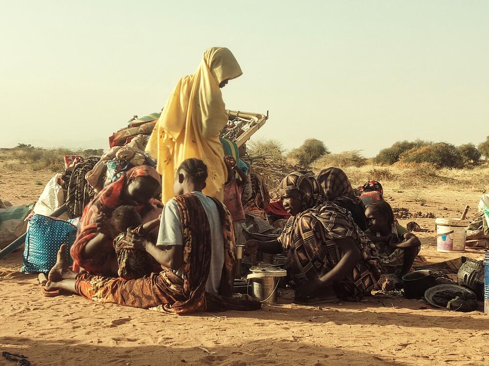 Displaced Sudanese, who fled the Zamzam camp, gather near the town of Tawila in North Darfur