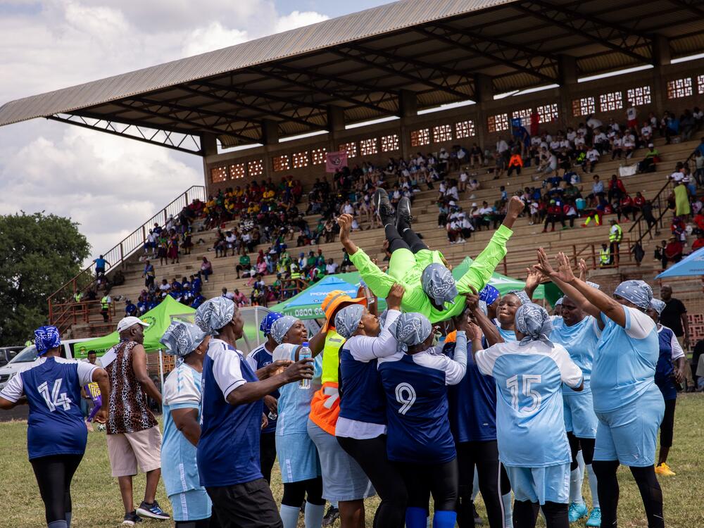 The Thulamahashe Grannies, a South African team, host a players into the air after their 1-0 victory over Kenya's Mutei Grannies.