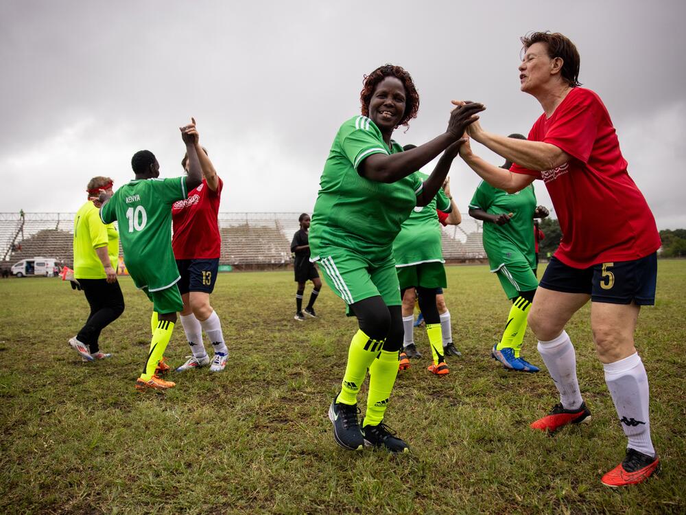 The Mutei Grannies from Kenya celebrate at the end of their game with the French team Le Reines du Foot — the first of the tournament's quarter finals. After the match, both teams embraced.