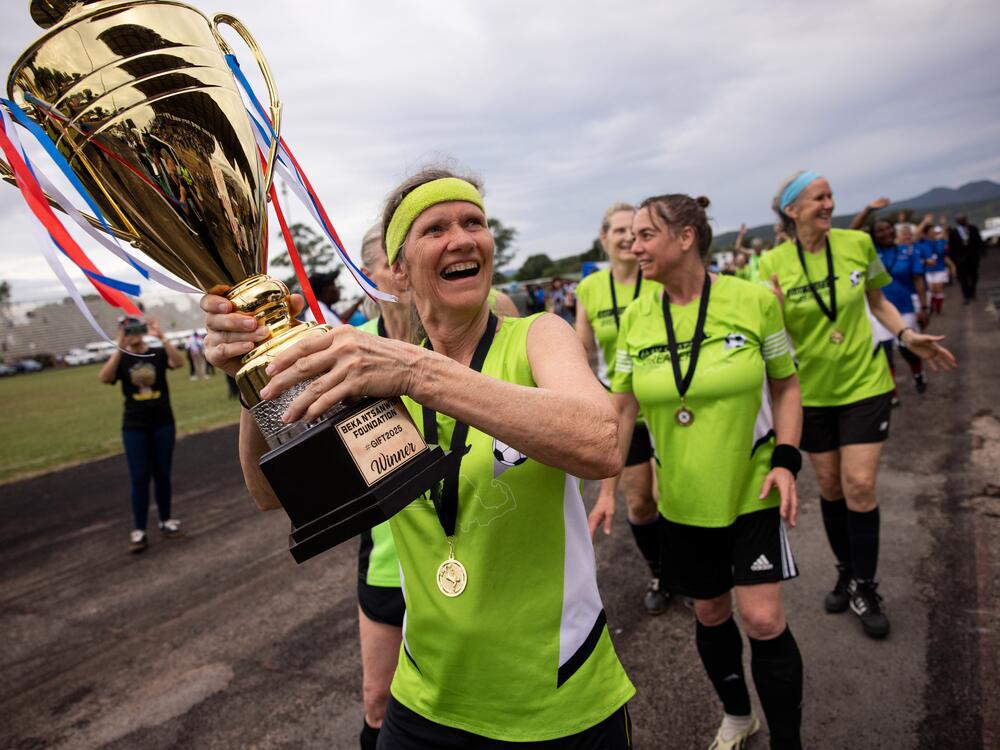 Members of the Boston Breakers hoist the trophy after beating the French team 