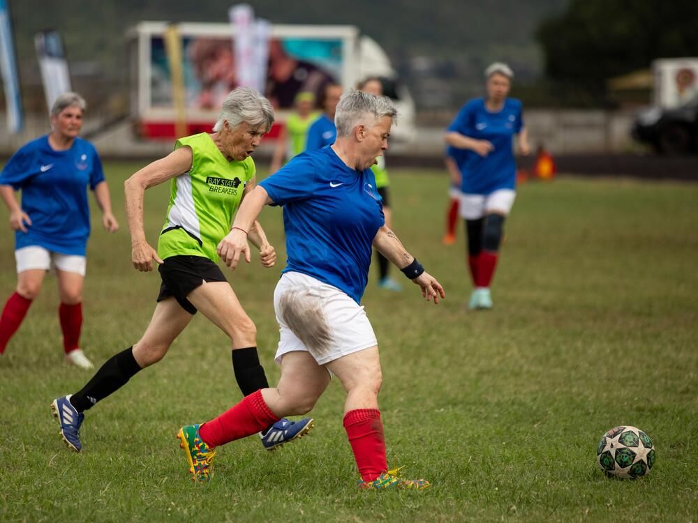 Laurance Gonzalez, 58, a player on the French team Les Zamies Foot, shows off her footwork. Gonzalez, pictured above in the foreground, wearing blue and white) won the award for best overall player at the tournament.