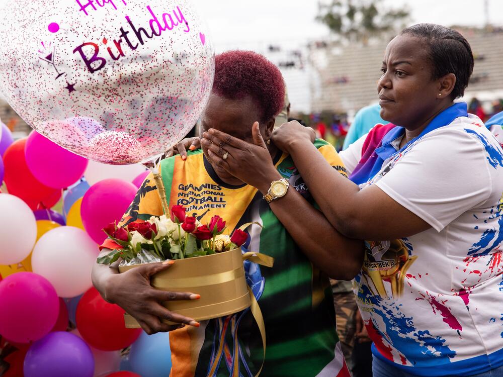 Beka Ntsanwisi (fondly known as Mama Beka) is the local philanthropist who organized the first granny games to help her town's women improve their health. Above: Ntsanwisi, center, wearing the yellow jersey) is given a surprise birthday cake on the last day of the event, when she turned 57.