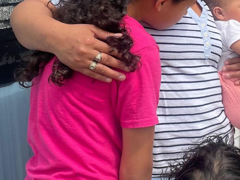 Mari hugs her children, all of whom are U.S. citizens. Mari has been adamant about staying in the U.S., while her husband says it's time for them to go back to Guatemala.