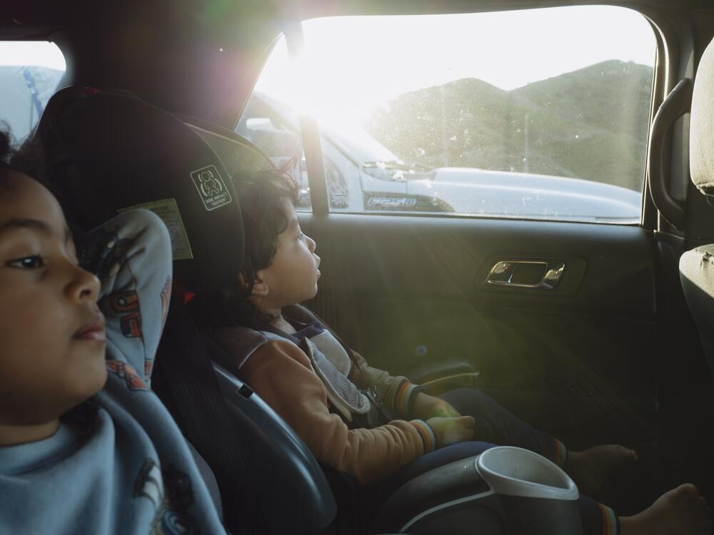 Yasmelin Valazquez's sons sit quietly as the family drives two hours to immigration court on April 10, 2025.