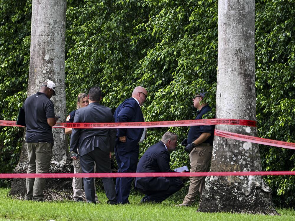 Law enforcement officials work at the crime scene outside the Trump International Golf Club in West Palm Beach, Fla., on September 16, 2024, following the attempted assassination on then-Republican presidential candidate Donald Trump. Ryan Routh is charged in the case and appeared at a federal court hearing on Tuesday in Fort Pierce, Fla.
