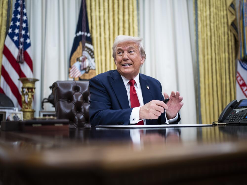 President Trump speaks to reporters and signs an executive order in the Oval Office on March 31.