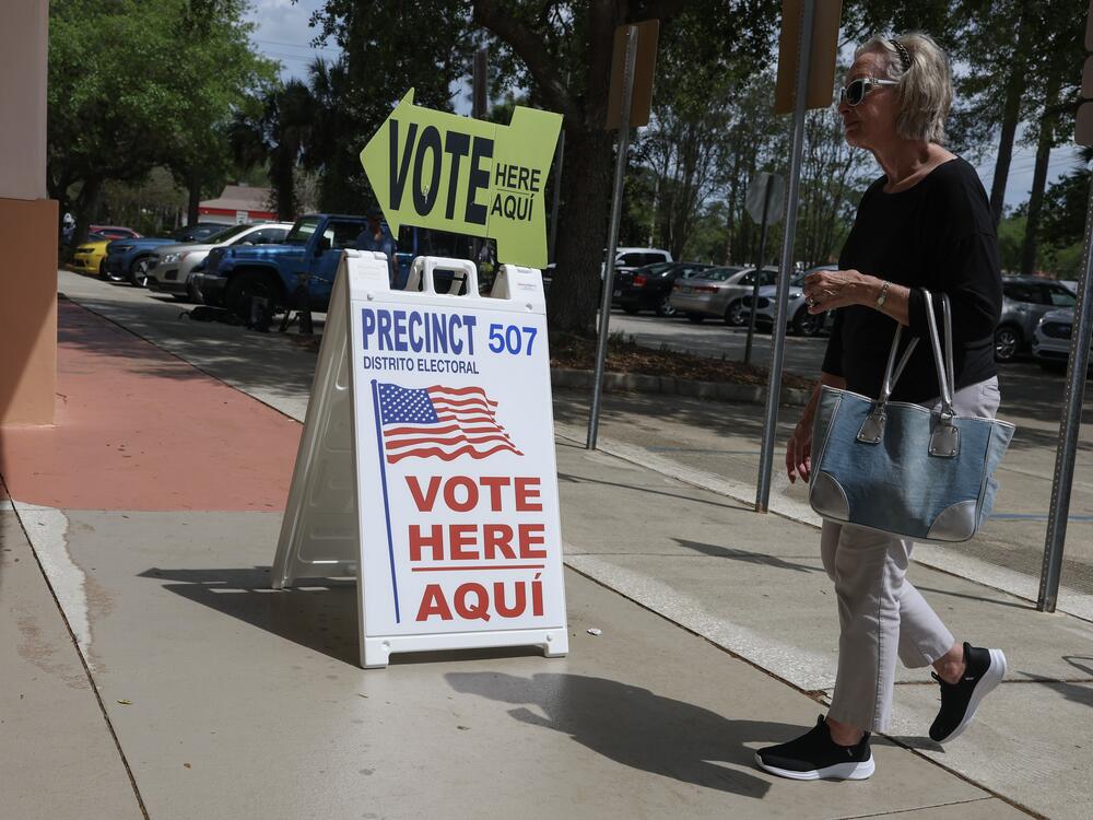 A sign directs voters to cast their ballots at a polling station set up at the Flagler County Public Library on April 1 in Palm Coast, Fla. People associated with DOGE are using Social Security data to advance debunked claims that large numbers of noncitizens are voting.