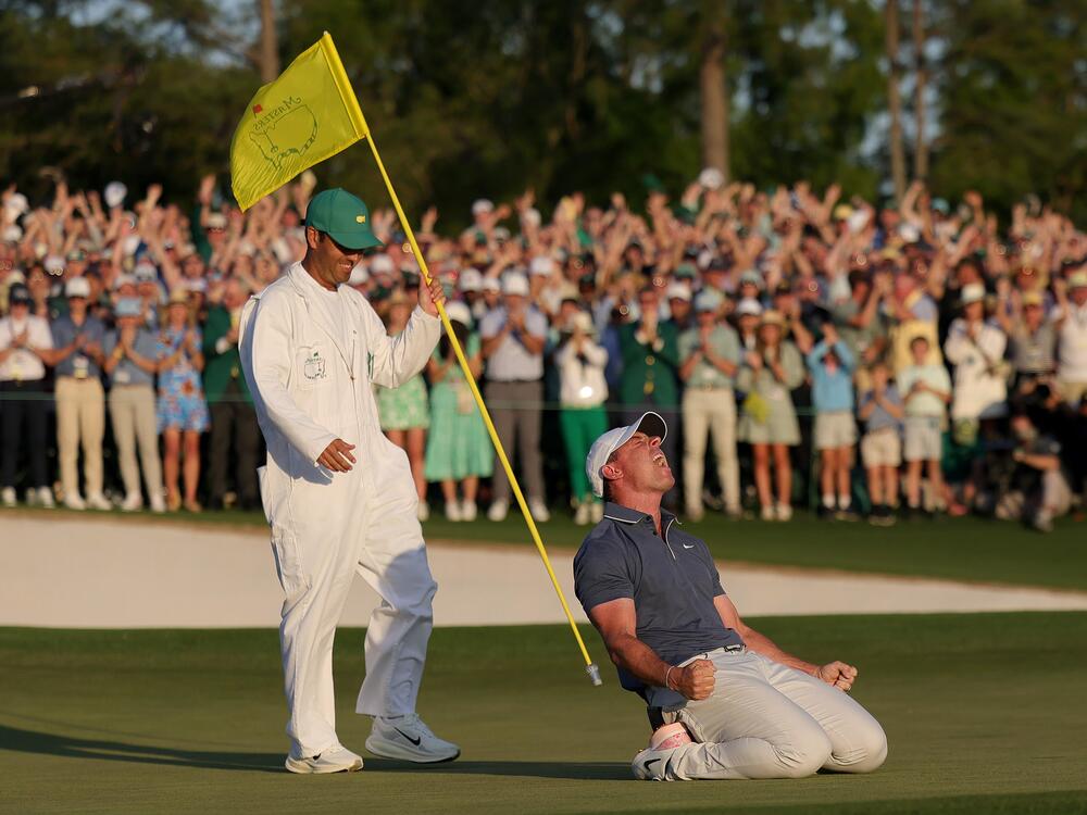 Rory McIlroy of Northern Ireland (R) celebrates winning with caddie Harry Diamond (L) after the playoff hole during the final round of the 2025 Masters Tournament at Augusta National Golf Club on April 13 in Augusta, Ga.