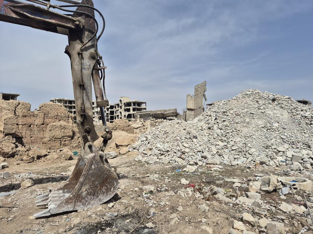 A backhoe was brought in to excavate mass graves in Jobar on March 26.