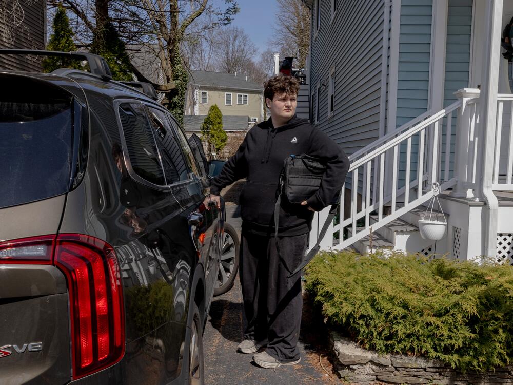 Logan heads to school, sometimes by bus and sometimes driven by his mother.