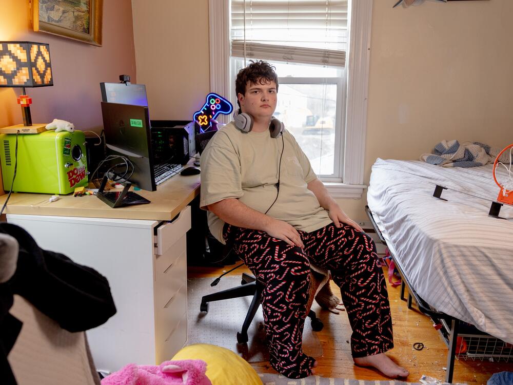 Logan sits in his room in his family's home in Newton, Mass. An avid gamer, he built the PC on the desk behind him. Logan asked that we only use his first name, so that he could speak freely about his experience and his disabilities.