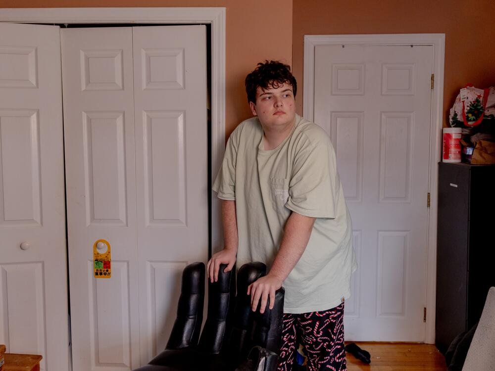 Logan, 17 and a junior at Newton South High School, stands in his room in Newton, Mass. Logan was part of a program called Charting My Path, which helps students with disabilities prepare for life after high school. The Trump administration cancelled the program in February. <br>