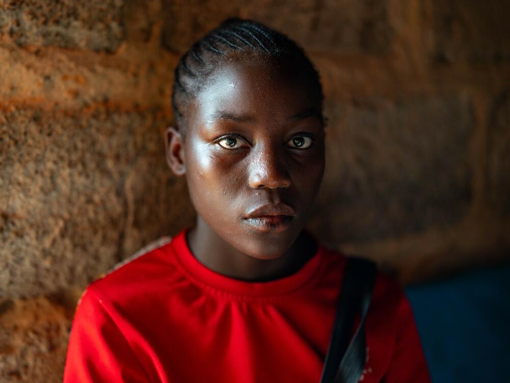 Catherine Mwaloe, 16, who contracted HIV from her mother at birth, has one month's supply of HIV medicine left. She worries that government clinics will charge money for the medications, which were previously free.