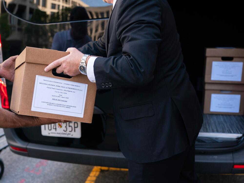 Workers load boxes of documents into a vehicle following the first day of a historic antitrust trial about Meta CEO Mark Zuckerberg's intentions in acquiring Instagram, at Barrett Prettyman United States Court House in Washington, Monday, April 14, 2025. (AP Photo/Nathan Howard)