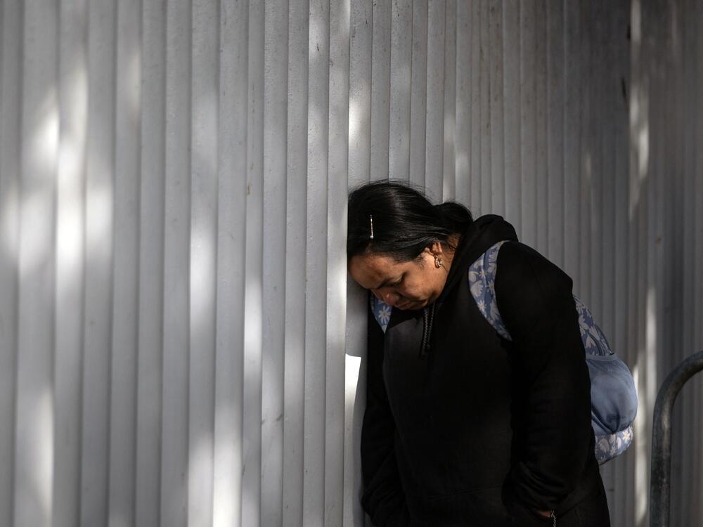 An asylum seeker reacts while waiting for news on her appointment with U.S. authorities before crossing through El Chaparral port in Tijuana, Baja California state, Mexico, on Jan. 20, 2025.