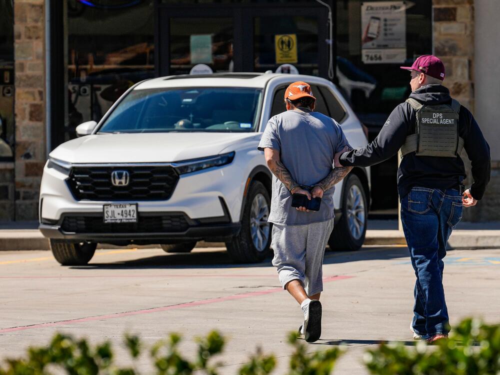 A man is detained by federal agents as Immigration and Customs Enforcement conducted raids on Feb. 24. The Trump administration has cracked down on migrants, including many in the U.S. with legal status. Now the White House is exploring a proposal to deport U.S. citizens to be incarcerated overseas.