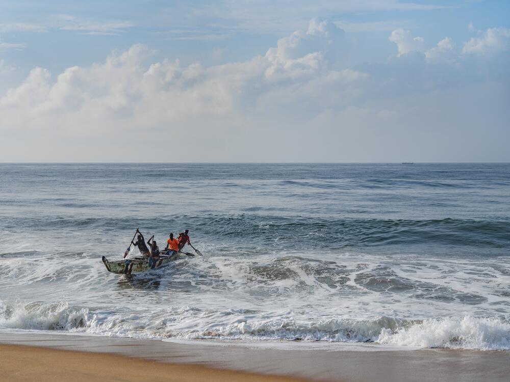 A boat returns to shore in Ivory Coast.