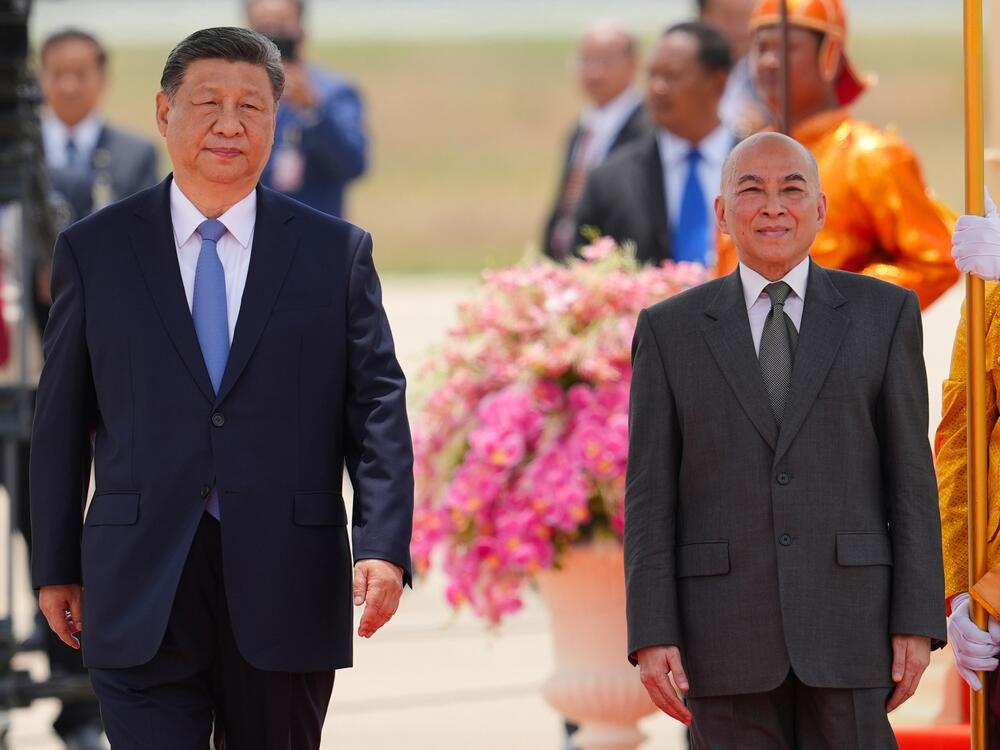 In this photo released by Agence Kampuchea Press (AKP), Cambodia's King Norodom Sihamoni, right, and Chinese President Xi Jingping attend a welcome ceremony at Phnom Penh International Airport in Phnom Penh, Cambodia, Thursday, April 17, 2025. (AKP via AP)
