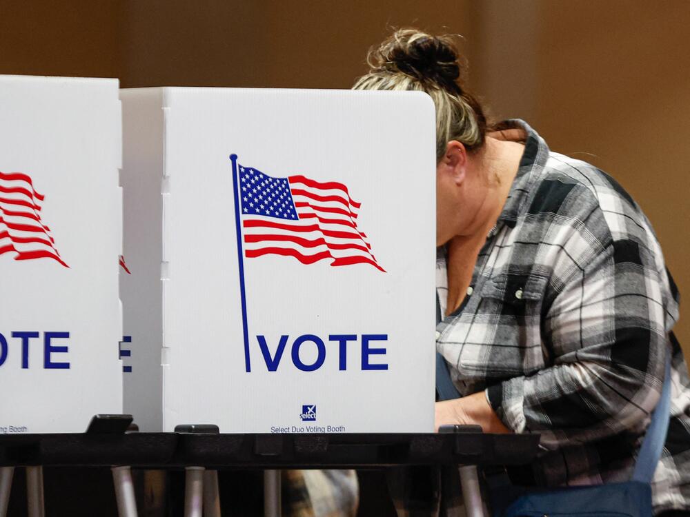 A woman votes at a polling location at The Chapel, an Evangelical church in St. Joseph, Mich., on Election Day, Nov. 5, 2024.
