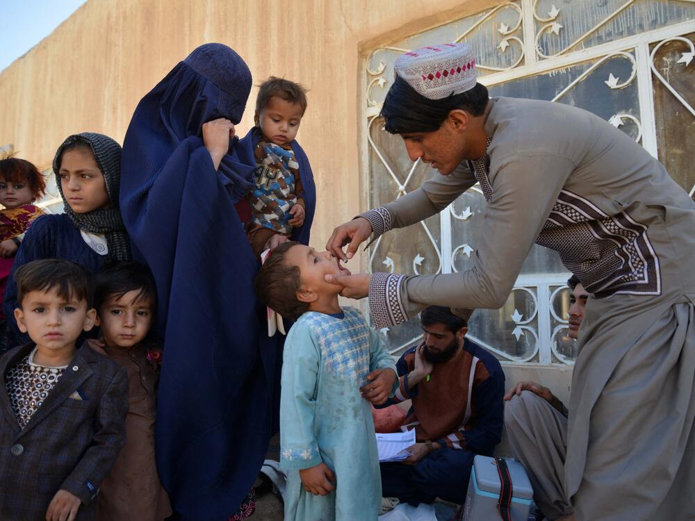 An Afghan health worker administers polio vaccine drops to a child during a polio vaccination campaign in Kandahar on December 23, 2024. The Taliban suspended door-to-door campaigns.