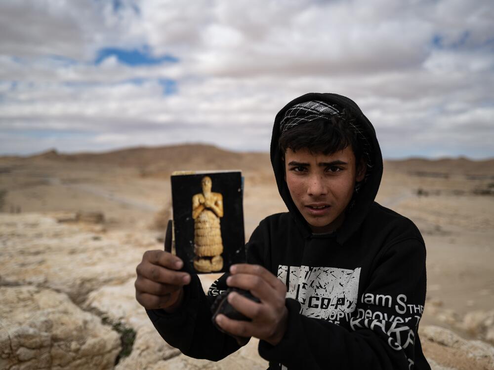 A young boy selling souvenirs above the ruins of Palmyra in February.