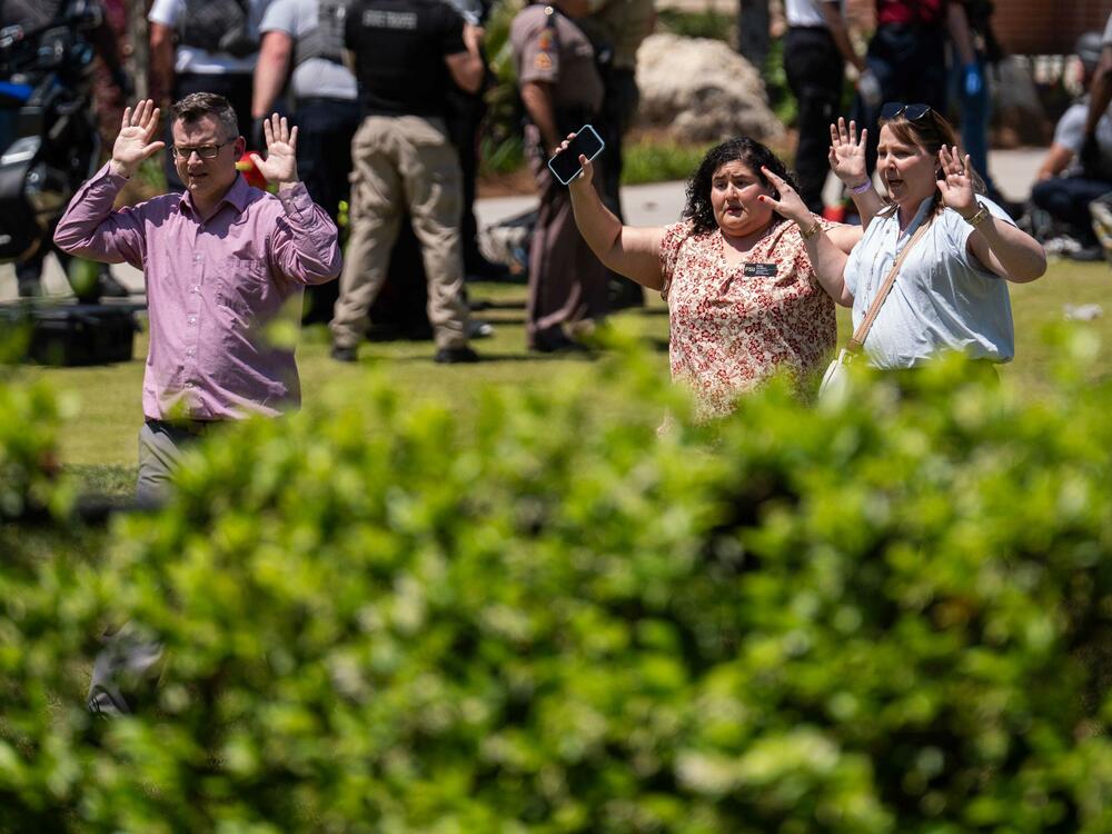Students, staff and others are escorted out of buildings after shots were fired on the campus of Florida State University on Thursday. Two people died and six others were hospitalized. The alleged gunman, the son of a local sheriff's deputy, was wounded.