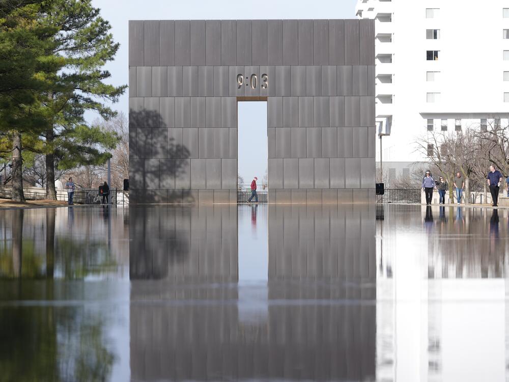 Visitors walk around the Reacting Pond at the Oklahoma City National Memorial & Museum in Oklahoma City on March 12, 2025.