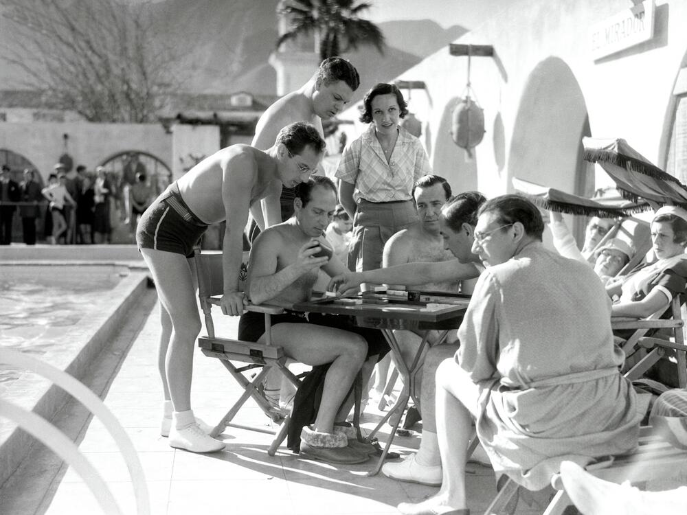 Celebrities including Zeppo and Harpo Marx play backgammon in Palm Springs, California, in this undated photo.