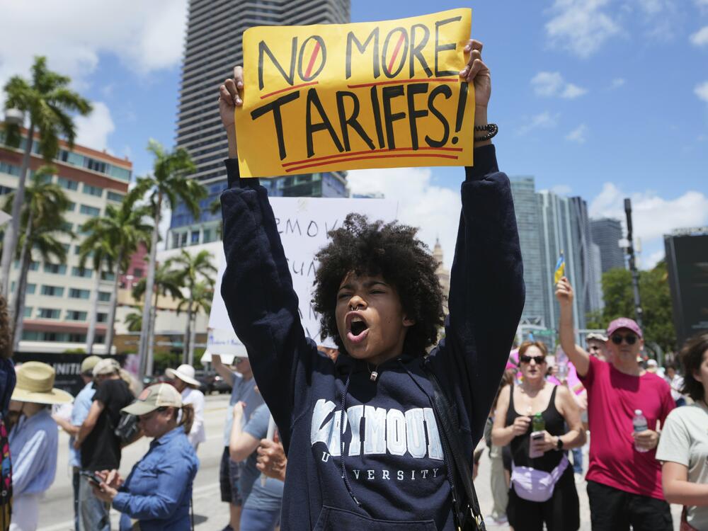 Paul Ivanov chants during a protest against the Trump administration on Saturday in Miami.