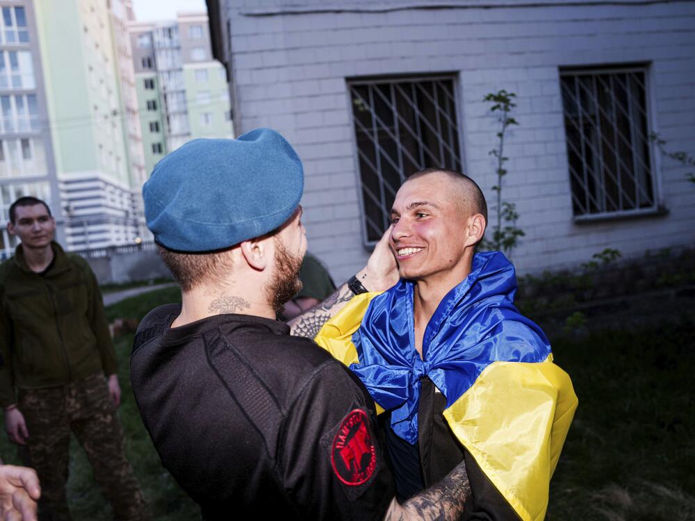 A Ukrainian soldier hugs his comrade after returning from captivity in a POW exchange in Ukraine, on Saturday.