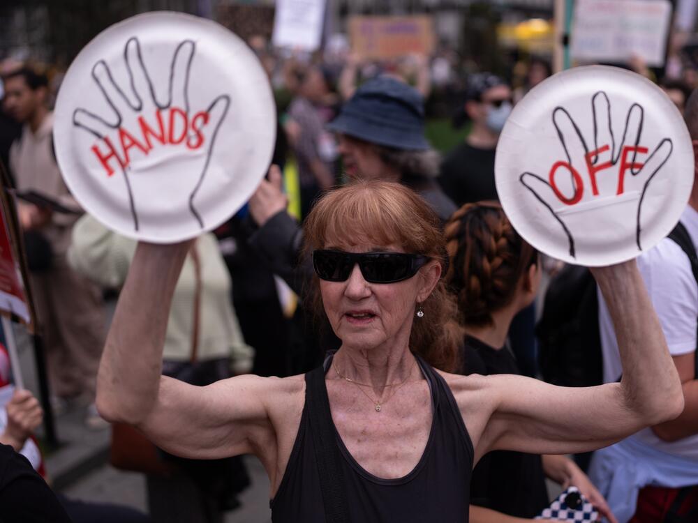 A protester holds a sign saying 