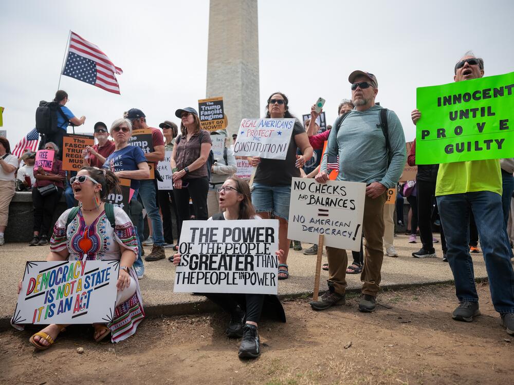 Heather Sarandos (C) from Baltimore holds up a sign while shouting during the anti-Trump protest in Washington, D.C., on Saturday.