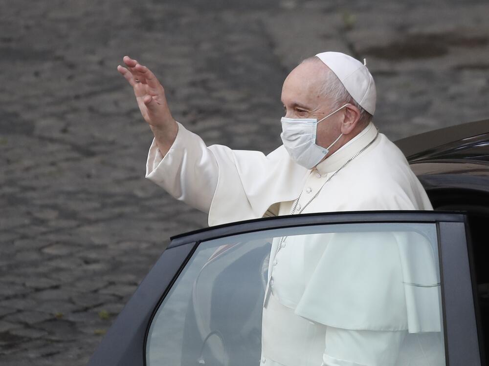 Pope Francis wears a face mask to curb the spread of COVID-19 as he arrives in the Vatican's San Damaso Courtyard for his weekly general audience on May 12, 2021.